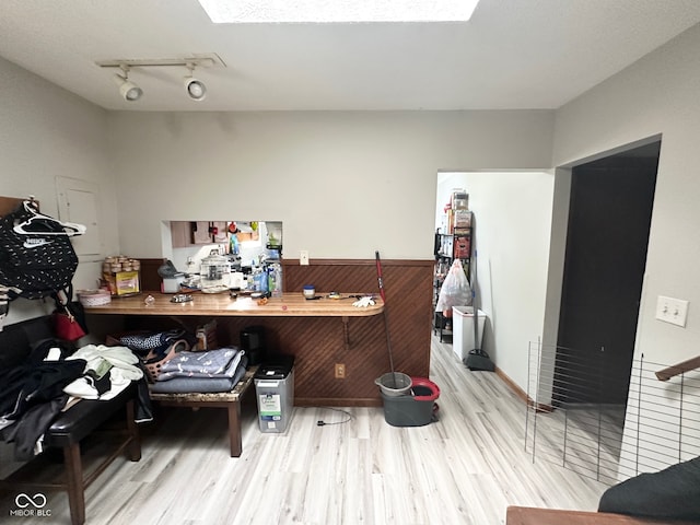 interior space with track lighting and light hardwood / wood-style floors