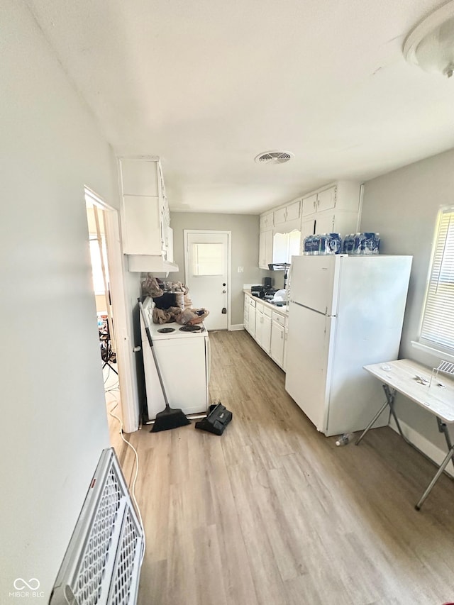 3521 N Riley Ave, Indianapolis, IN 46218 - kitchen featuring light wood finished floors, white appliances, white cabinetry, and visible vents