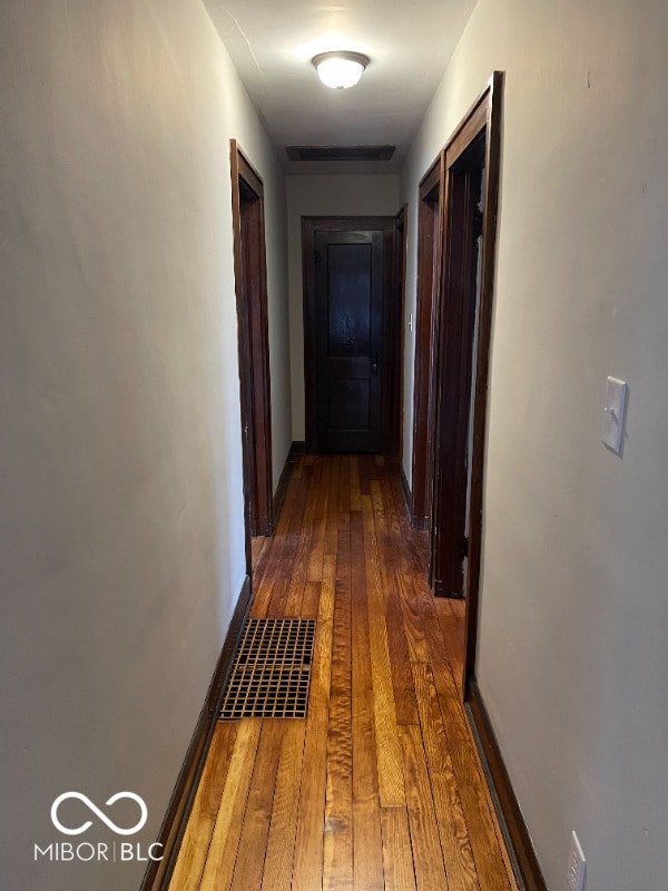 corridor featuring dark hardwood / wood-style flooring