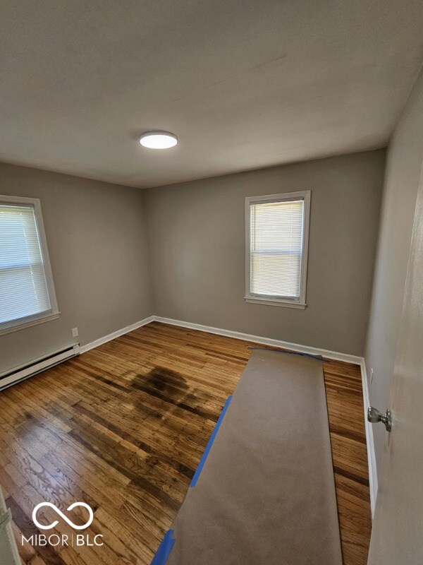 empty room with hardwood / wood-style floors