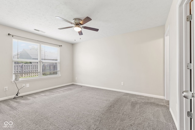 carpeted empty room with a textured ceiling and ceiling fan