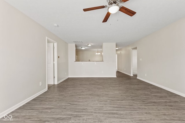 unfurnished living room with ceiling fan and dark wood-type flooring