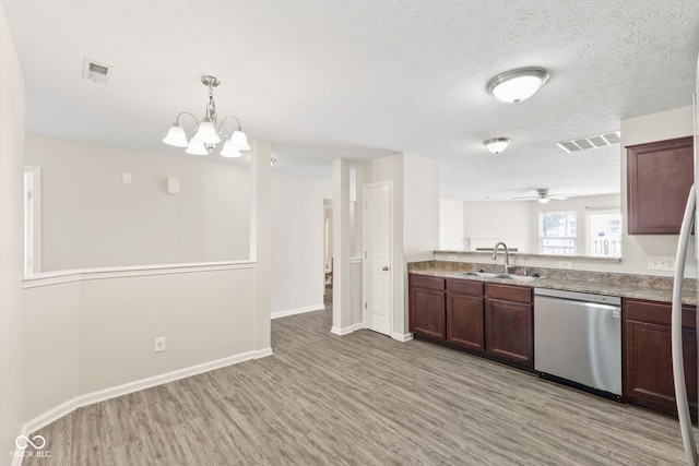 kitchen with dishwasher, sink, pendant lighting, ceiling fan with notable chandelier, and light wood-type flooring