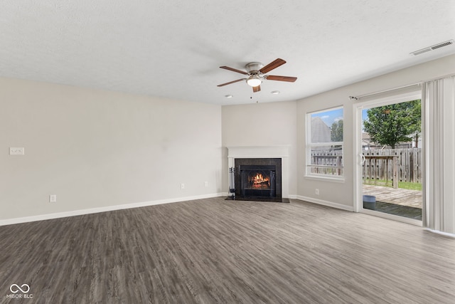 unfurnished living room with hardwood / wood-style floors, a textured ceiling, and ceiling fan