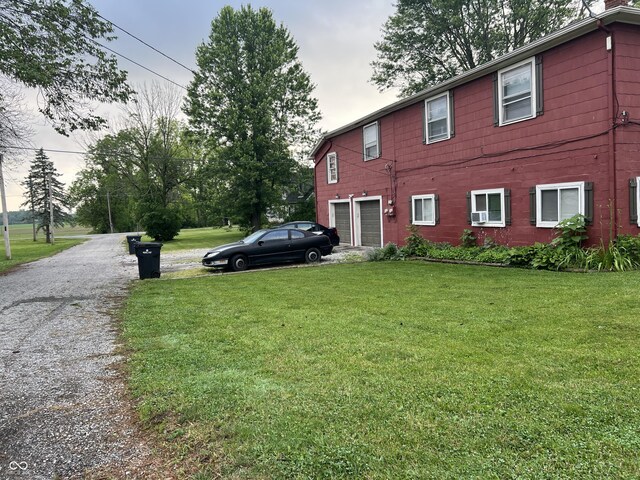 exterior space with a garage and a yard