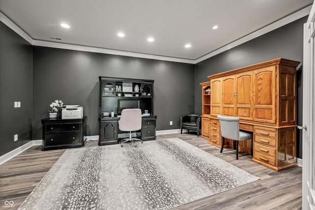 home office featuring hardwood / wood-style floors and crown molding