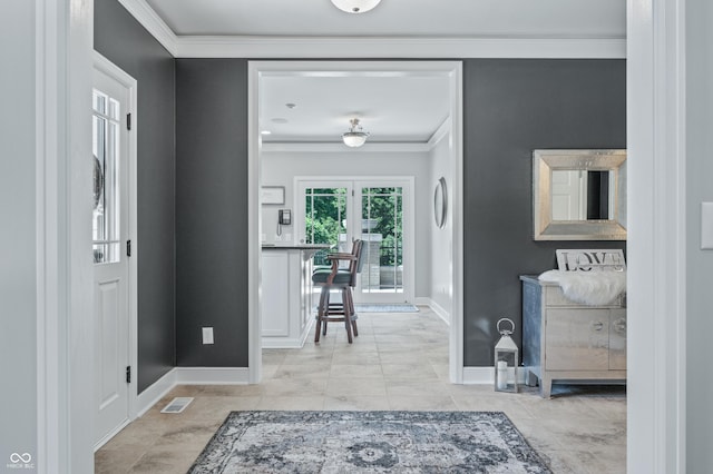 foyer entrance featuring ornamental molding