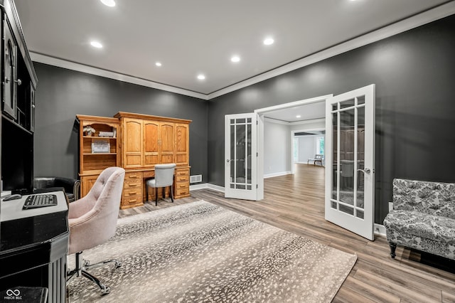 home office with french doors, light wood-type flooring, and crown molding