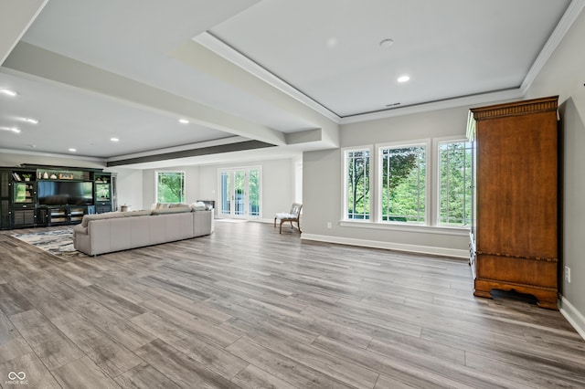 unfurnished living room featuring light hardwood / wood-style flooring and ornamental molding