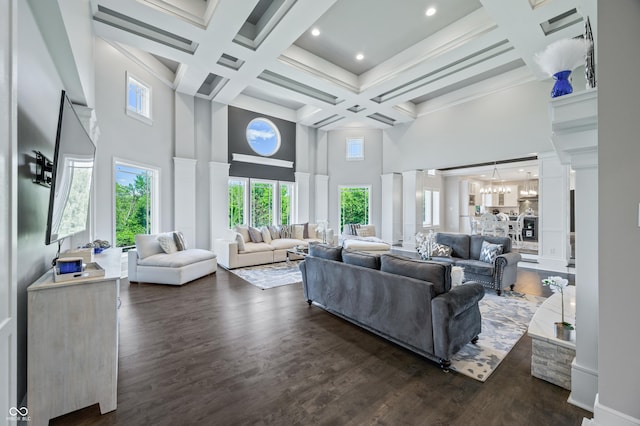 living room featuring coffered ceiling, dark hardwood / wood-style flooring, beamed ceiling, and a high ceiling