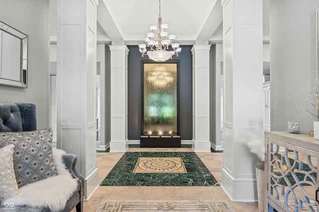 entrance foyer with a chandelier and ornate columns