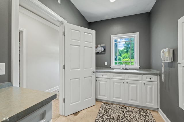 interior space featuring sink and light tile patterned floors