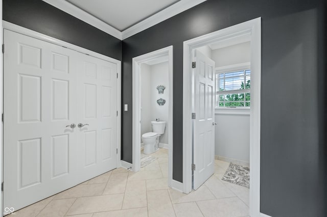 bathroom with tile patterned floors, toilet, and ornamental molding