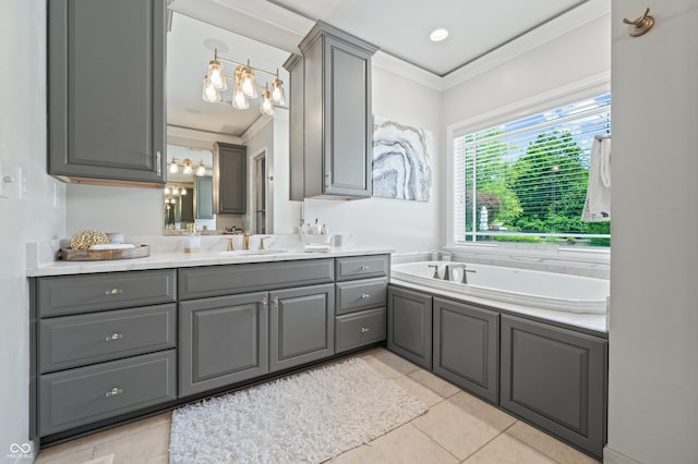 bathroom with vanity, a tub to relax in, tile patterned floors, and ornamental molding