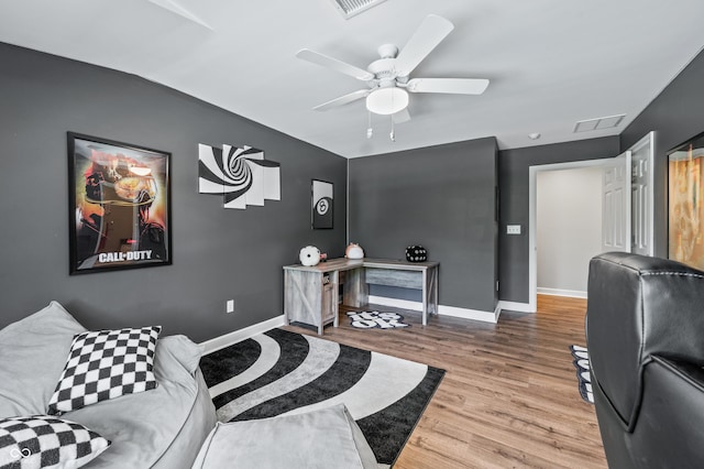 living room featuring ceiling fan and light hardwood / wood-style flooring