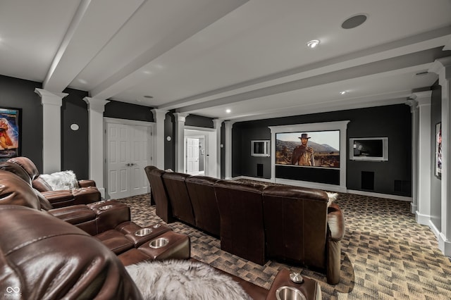 carpeted home theater with beamed ceiling