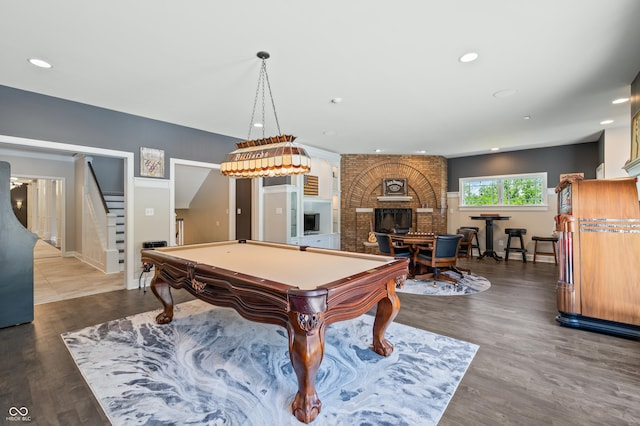 rec room featuring a brick fireplace, hardwood / wood-style floors, and pool table