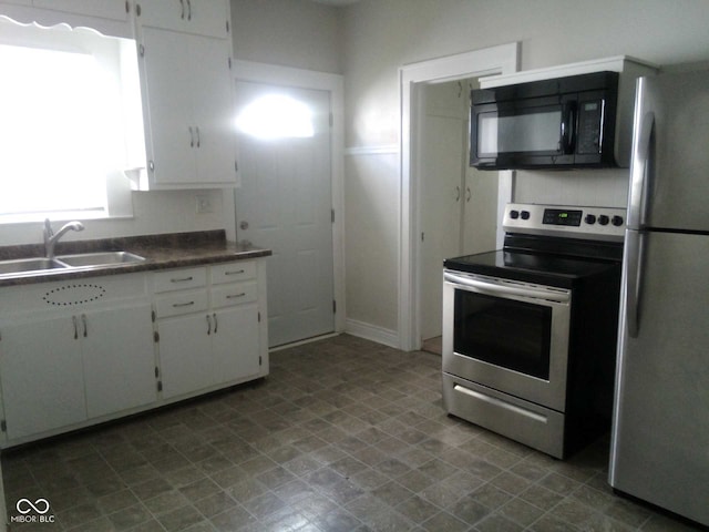 kitchen featuring sink, white cabinets, and appliances with stainless steel finishes