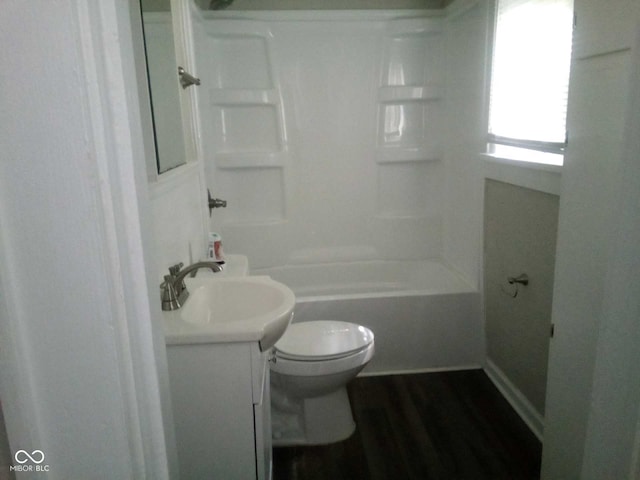 full bathroom with bathtub / shower combination, wood-type flooring, vanity, and toilet