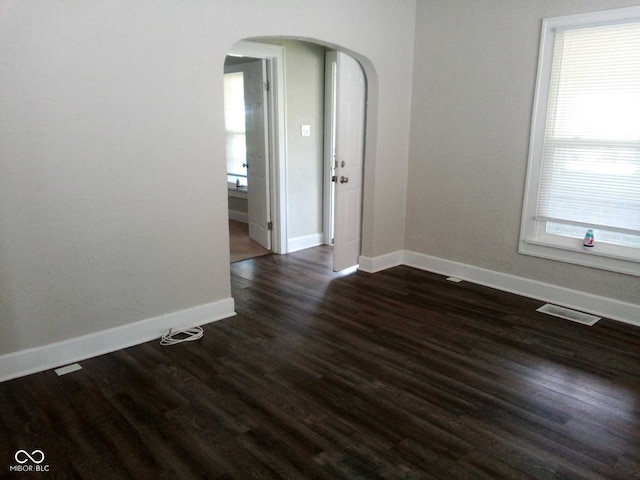 empty room featuring dark wood-type flooring