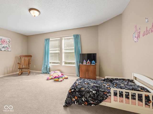 bedroom featuring carpet and a textured ceiling