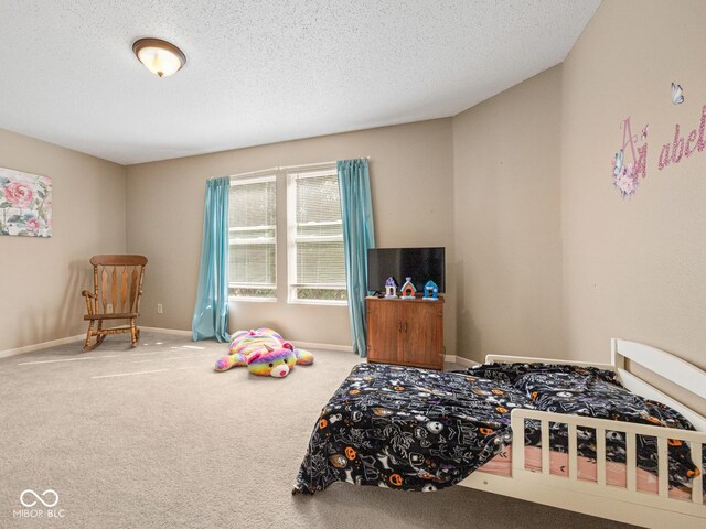 bedroom featuring carpet and a textured ceiling