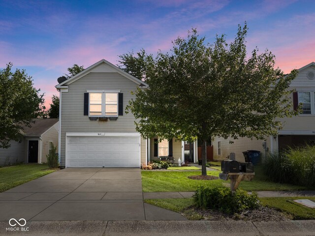 view of front facade featuring a yard and a garage