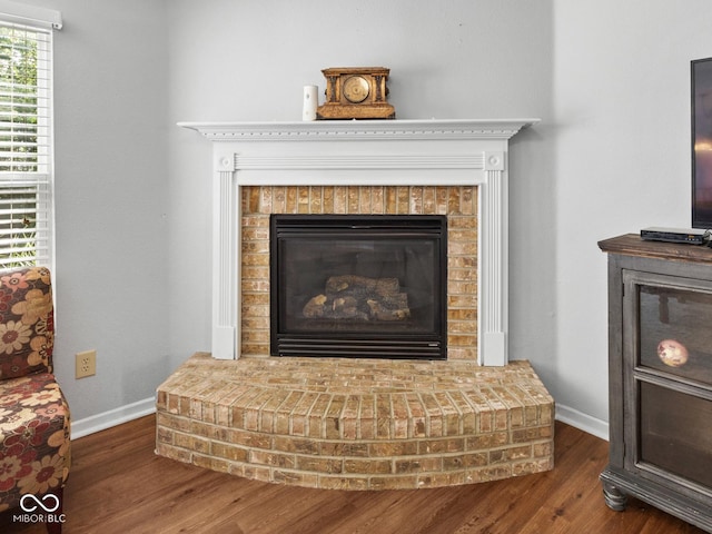 room details with hardwood / wood-style floors and a brick fireplace