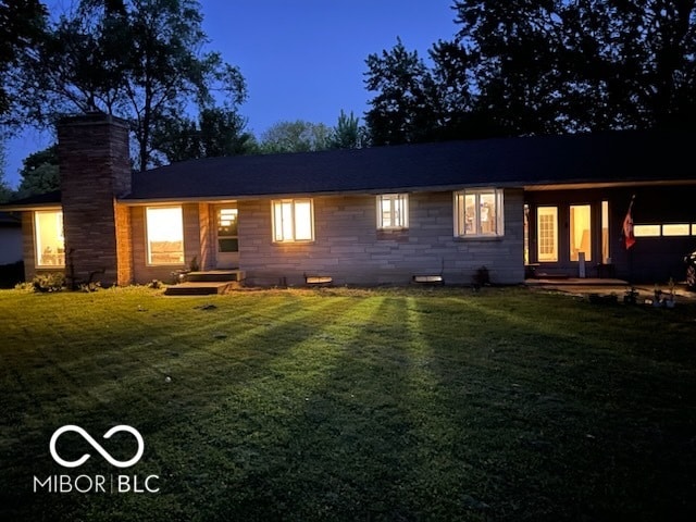 back of house featuring a lawn