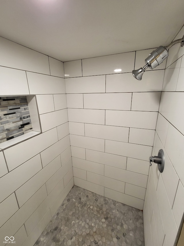 bathroom with tiled shower