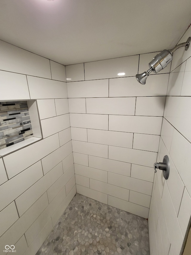 bathroom with tiled shower