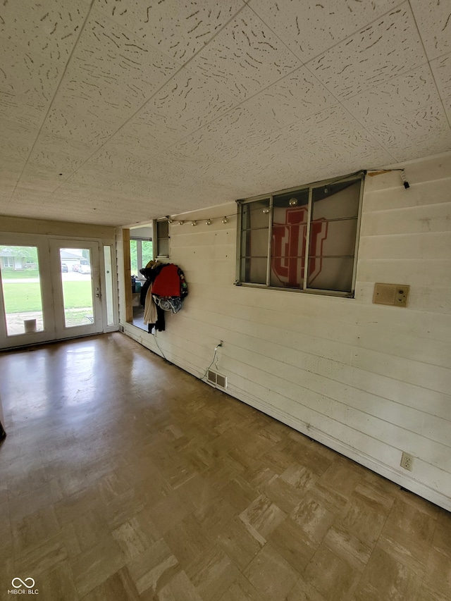 interior space with a paneled ceiling