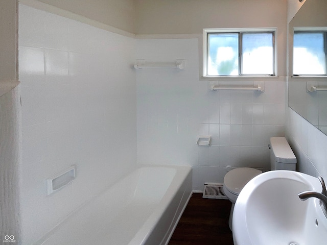 bathroom with toilet, sink, tile walls, and hardwood / wood-style flooring