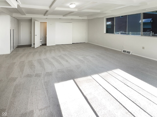 interior space with beam ceiling, light carpet, and coffered ceiling