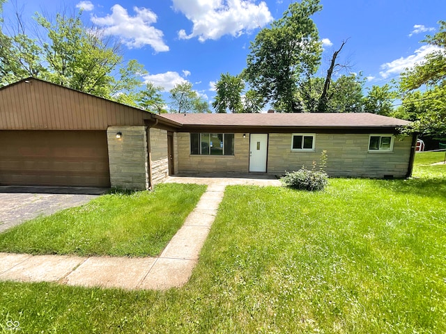 ranch-style home with a front lawn and a garage