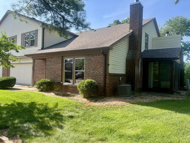 2424 N Willow Way, Indianapolis, IN 46268 - rear view of property featuring brick siding, a lawn, and roof with shingles