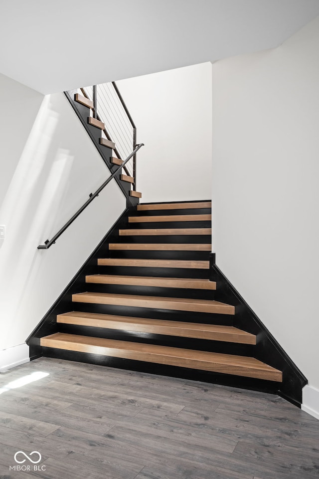 stairs featuring wood-type flooring