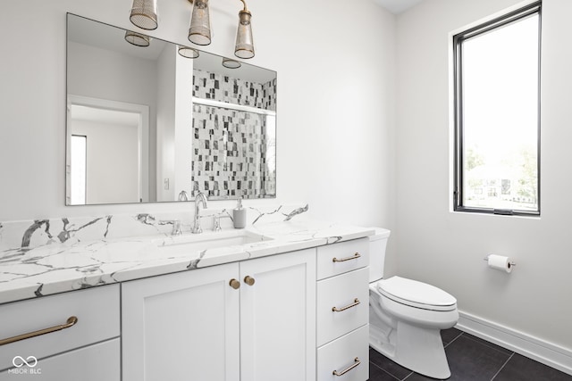 bathroom featuring tile patterned floors, vanity, and toilet