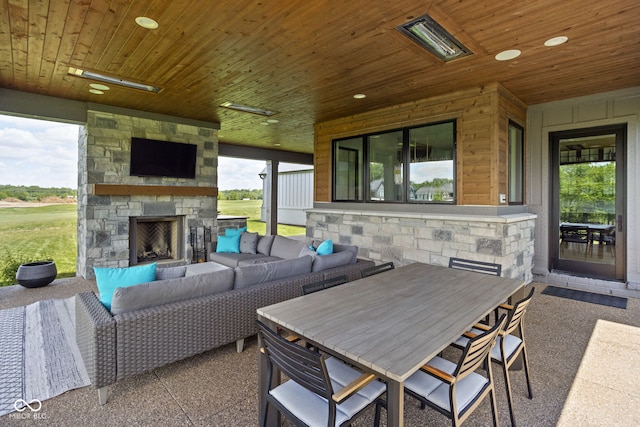 view of patio featuring an outdoor living space with a fireplace