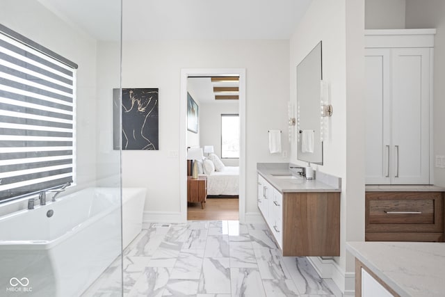 bathroom featuring a washtub and vanity