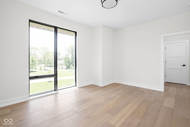 spare room featuring light hardwood / wood-style flooring