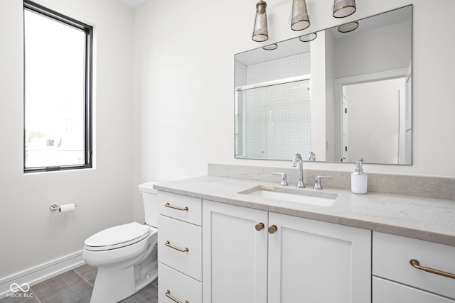 bathroom with tile patterned flooring, vanity, toilet, and a shower with shower door