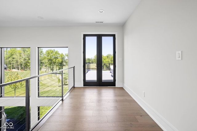 doorway to outside featuring french doors and hardwood / wood-style flooring