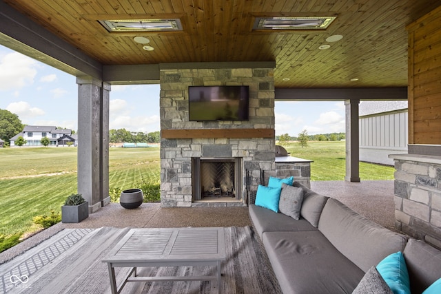 view of patio with an outdoor living space with a fireplace