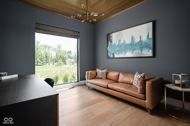 office space featuring light hardwood / wood-style floors, wooden ceiling, and an inviting chandelier