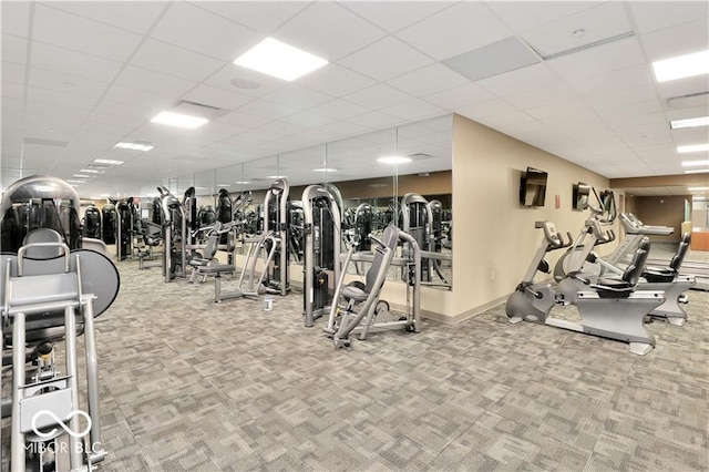 exercise room with carpet flooring and a drop ceiling