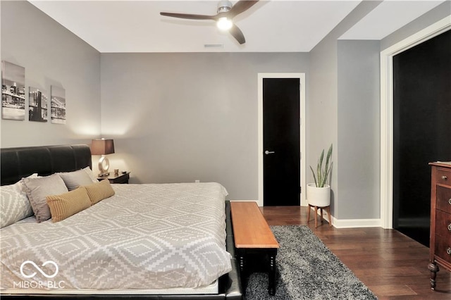 bedroom with dark hardwood / wood-style floors and ceiling fan