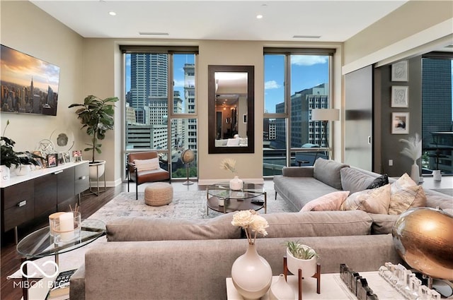 living room featuring wood-type flooring and expansive windows