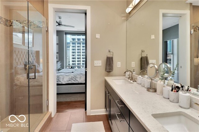 bathroom featuring double vanity, an enclosed shower, ceiling fan, and tile floors