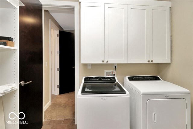 washroom featuring separate washer and dryer, washer hookup, carpet floors, and cabinets